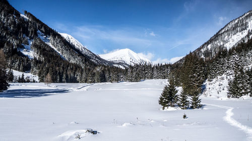 Scenic view of snow covered mountains against sky