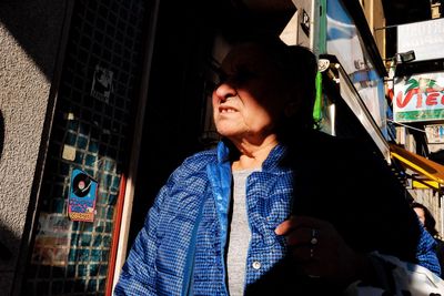 Portrait of young woman using mobile phone at night