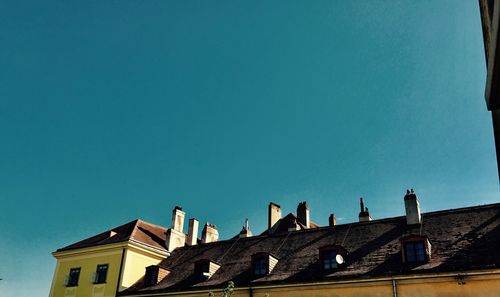 Low angle view of houses against clear sky