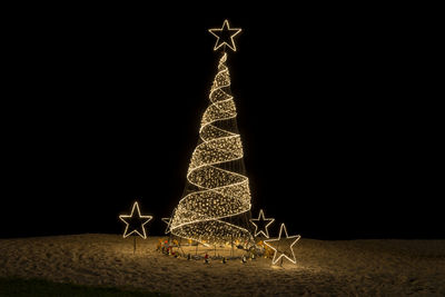 Illuminated christmas tree at night