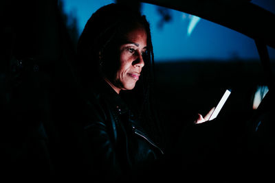 Man using smart phone in car