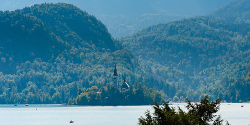 Scenic view of sea and mountains against sky