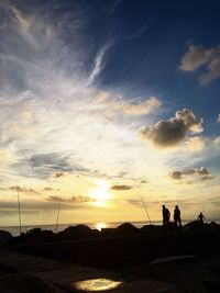 Silhouette of man against cloudy sky