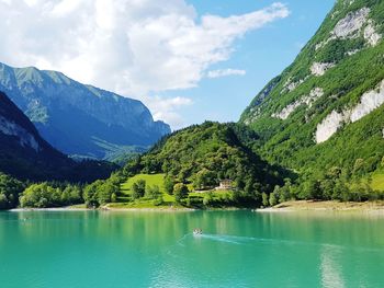 Scenic view of lake and mountains against sky