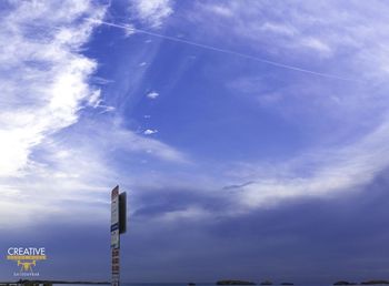 Low angle view of vapor trail against blue sky