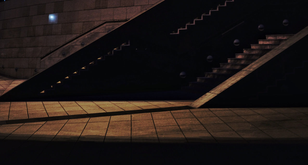 architecture, staircase, indoors, built structure, flooring, steps and staircases, railing, no people, absence, shadow, illuminated, dark, tile, pattern, sunlight, nature, wood - material, tiled floor, empty