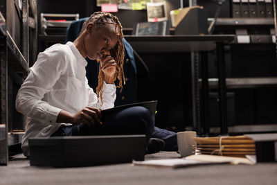 Young woman using laptop at table