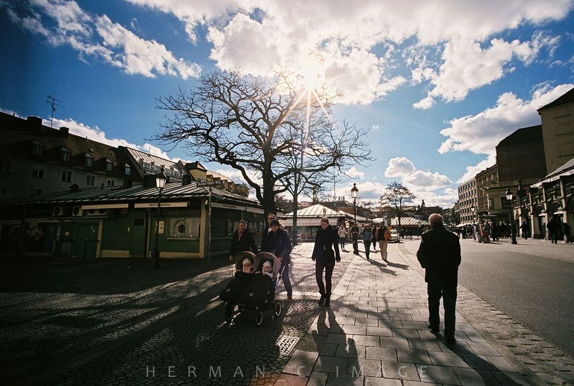 building exterior, architecture, built structure, sky, men, walking, lifestyles, person, cloud - sky, city, cloud, leisure activity, residential structure, full length, sunlight, shadow, residential building, street, house