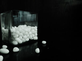 Close-up of balls in glass container on table