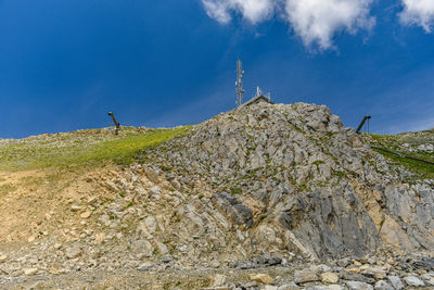 Low angle view of mountain against blue sky