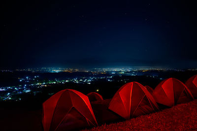 Aerial view of illuminated tent against sky at night