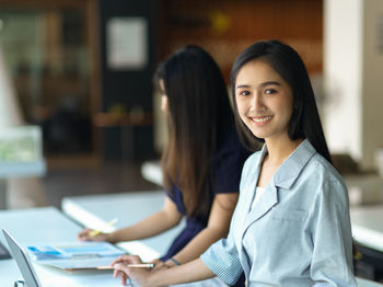 Smiling businesswomen working at office