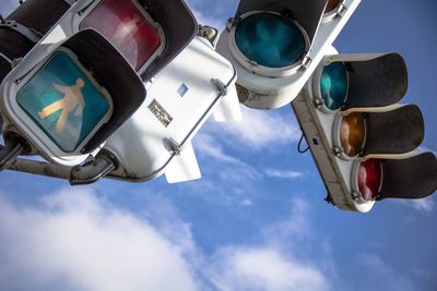 Low angle view of traffic signal against sky