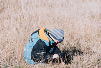 Cute boy playing on grassy field