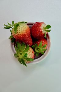 Close-up of strawberries in bowl against white background