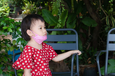 Four years asian girl take off face mask during quarantine for coronavirus pandemic prevention.