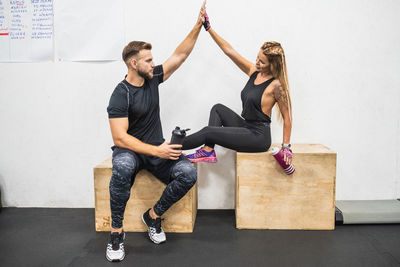 Young couple sitting on wall