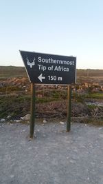 Information sign against sky