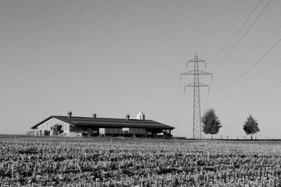 Barn on field against clear sky