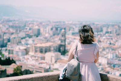 Rear view of woman looking at cityscape