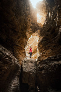 Low angle view of person standing on rock