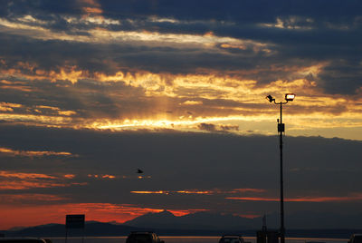 Low angle view of silhouette street against sky during sunset