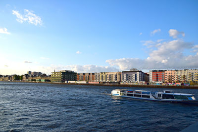 Boats in river with buildings in background