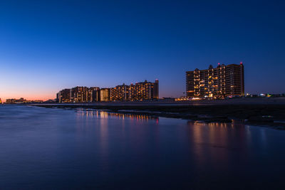 Illuminated city at waterfront