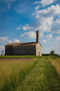 Built structure on field against sky