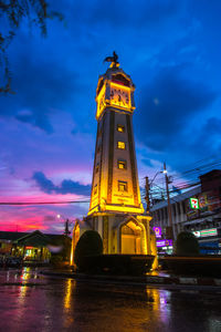 Low angle view of illuminated tower at night