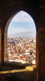 Cityscape against sky seen through arch