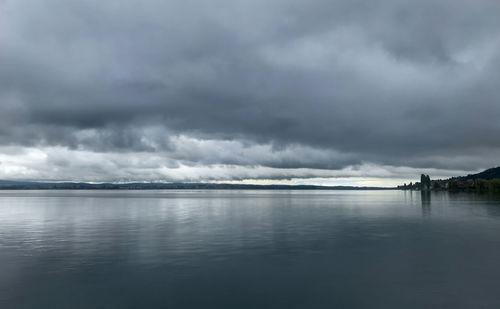 Scenic view of sea against storm clouds