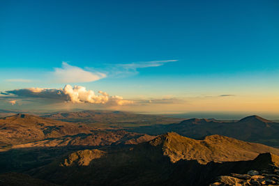 Scenic view of dramatic landscape against sky during sunset