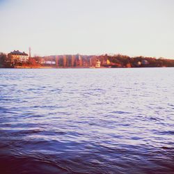 Scenic view of sea with buildings in background