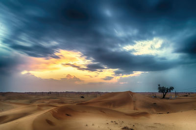 Scenic view of desert against sky during sunset