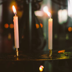 Close-up of lit candle in dark room