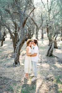 Rear view of couple standing on field