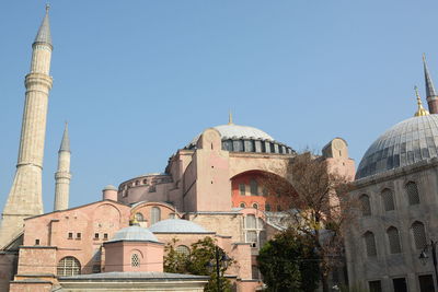 Low angle view of buildings against blue sky