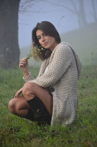 Portrait of young woman in grass