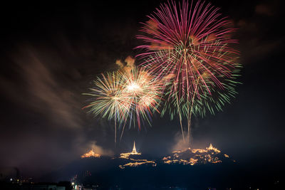 Low angle view of firework display against sky at night