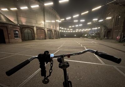 Man riding bicycle on road at night
