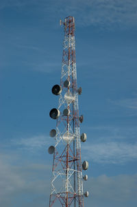 Low angle view of communications tower against sky