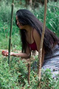 Woman holding fruit in forest