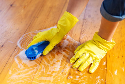 Low section of man standing on hardwood floor