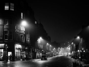 Illuminated city street at night