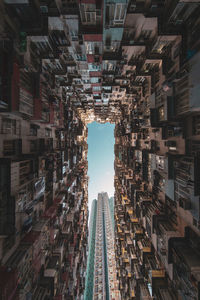 Directly below shot of buildings in city against sky