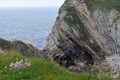 Scenic view of sea and rocks against sky