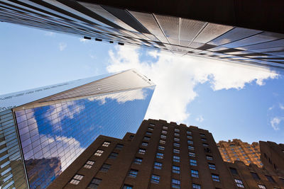 Low angle view of one world trade center and modern buildings against sky