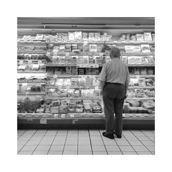 Rear view of woman standing in front of building