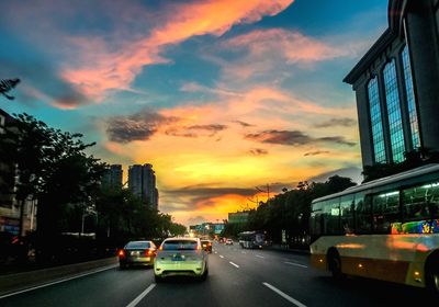 View of city street at sunset